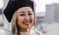 Woman with blonde hair wears graduation cap and white dress.