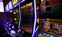 a row of poker machines, which some Victorian AFL teams still make large profits from