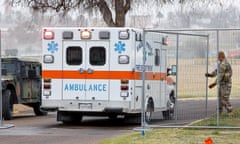 National Guardsmen let in an ambulance through a gate of the Shelby Park in Eagle Pass, Texas, 14 January 2024. 