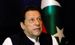 Former Pakistani PM Imran Khan pictured in front his party's flag during an interview in Lahore