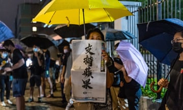 A supporter holds up a copy of the Apple Daily newspaper outside its offices in Hong Kong.