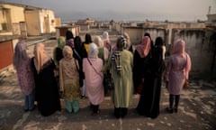 A group of Afghan women prosecutors stand on a rooftop overlooking Islamabad, Pakistan