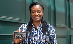 Valerie Labi holding a smartphone with an image of a Wahu ebike on the screen