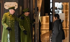 Door staff greet a shopper at the Harrods store in London