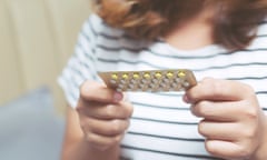 A woman with birth control pills.