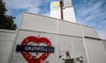 Mocked-up tube sign reading "Grenfell" on wall beneath tower