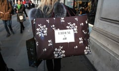 A shopper carries an Erdem x H&M bag