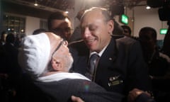 Pilot Captain Amr al-Jamal (R) and a passenger (L) of the EgyptAir Airbus A-320 embrace after they arrive at Cairo international airport