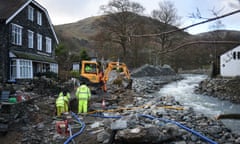 BRITAIN-WEATHER-FLOOD<br>Wokmen use a machine to excavate the Ulls Water to improve its drainage after it flooded the village following a period of heavy rainfall in Glenridding, northwest England, on December 10, 2015. Heavy overnight rain on December 10 piled further misery on parts of northwest England still reeling from Storm Desmond, which left two people dead, with police warning the situation remained "extremely dangerous". AFP PHOTO / OLI SCARFF / AFP / OLI SCARFF (Photo credit should read OLI SCARFF/AFP/Getty Images)