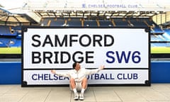 Sam Kerr poses following the signing of her contract extension at Stamford Bridge.