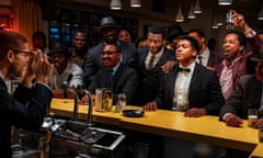 Kingsley Ben-Adir as Malcolm X, left, taking a photo of Aldis Hodge (standing, centre, in white shirt) as Jim Brown, Eli Goree (in tux) as Cassius Clay and Leslie Odom Jr (raising glass) as Sam Cooke in One Night in Miami.