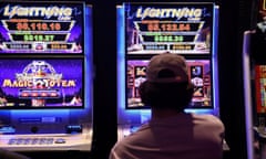 A person gambles on a poker machine.