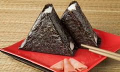 Fresh made Japanese onigiri packed in seaweed on a dish