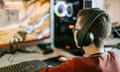 Teenager wearing headphones playing video game