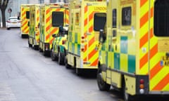 Line of ambulances queued up on road. 