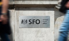 Pedestrians walk past a Serious Fraud Office sign outside the agency’s headquarters