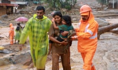 Rescuers help residents at the site of a landslide in Wayanad, Kerala, India.