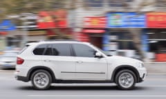 BMW X5 being driven on a city street