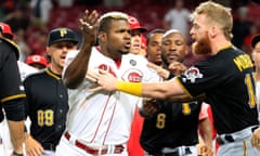 Yasiel Puig is restrained during a confrontation in the Reds-Pirates game
