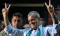 Masoud Pezeshkian flashes victory signs at a campaign rally