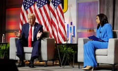 Donald Trump answers questions as moderator and journalist Rachel Scott looks on during the National Association of Black Journalists annual convention.