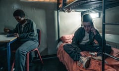 Tamara Lawrence, at a desk, and Bella Ramseym on the bottom bunk, looking to camera, in a prison cell in series two of Time.