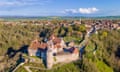 Aerial view of abbey with village in distance