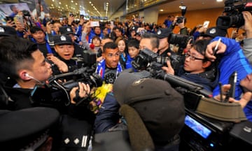 Carlos Tevez makes his way through the arrivals halls at Shanghai Pudong International Airport.