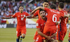 Chile’s Jose Pedro Fuenzalida celebrates his goal as he jumps in the arms of Mauricio Isla.