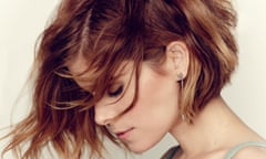 Kate Mara in profile, hair swept forward, eyes closed, strappy top