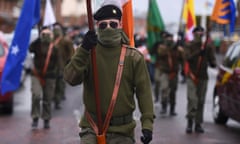 Masked members of Republican Sinn Fein commemorate the 100 year anniversary of the Irish Easter Rising in Lurgan, Northern Ireland March 26, 2016. REUTERS/Clodagh Kilcoyne