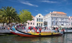 A Moliceiro (a boat formerly used for collecting seaweed) taking aboard visitors to see the canals of Aveiro, Portugal<br>P8T967 A Moliceiro (a boat formerly used for collecting seaweed) taking aboard visitors to see the canals of Aveiro, Portugal