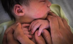 A mother holds her newborn baby.