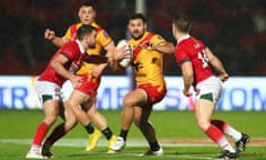 Rhyse Martin of Papua New Guinea looks to break past Wales players during the Rugby League World Cup in 2022