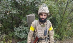 A man in military uniform in a forest clearing