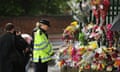  A police officer stops to look at flowers laid close to the scene in Woolwich where Fusilier Lee Rigby was killed in May 2013.