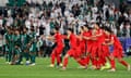 South Korea’s players erupt with joy as Saudia Arabia’s despair at the end of the Asian Cup last-16 penalty shootout.