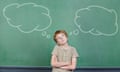 Child making a decision in school in front of chalkboard with thought bubbles<br>DYNFPE Child making a decision in school in front of chalkboard with thought bubbles