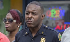 In this Jan. 2, 2016, photo, Miami Police Maj. Delrish Moss stands among the Miami-Dade officials who announced the arrest of Willie "Pee Wee" Wilcher in Liberty City, Fla. Moss was announced as police chief in Ferguson, Mo., Thursday, March 31, 2016, putting a black man in charge of a mostly white department that serves a town where African-Americans make up two-thirds of the residents. (Matias J. Ocner/The Miami Herald via AP) MAGS OUT; MANDATORY CREDIT