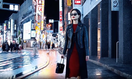 A still from a video created using Sora, the AI generation platform being developed by OpenAI shows a woman walking down a Japanese street at night