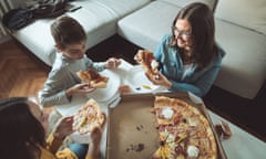 Family eating pizza at home