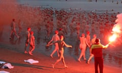 Swimmers make their way into the water