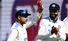 India's Kuldeep Yadav holds a ball to the crowd after taking five wickets in the first inning.