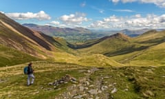 Female hiker looking North East down the Coledale Vally towards Braithwaite on the Coledale Horshoe trail in the Lake District.<br>RA0HRT Female hiker looking North East down the Coledale Vally towards Braithwaite on the Coledale Horshoe trail in the Lake District.