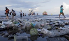 Tourists and local residents disembark a boat coming from nearby Nusa Penida island as plastic trash pollutes the beach in Sanur, Denpasar, Bali, Indonesia April 10, 2018.