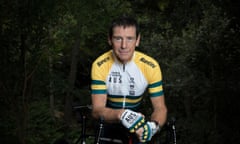 Roger Cull wearing professional biking gear in Australian colours, staring directly at the camera