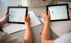 Secondary education Wales UK - two girls holding using Apple iPad iPads tablet computers in a biology science class classroom<br>E71YXT Secondary education Wales UK - two girls holding using Apple iPad iPads tablet computers in a biology science class classroom