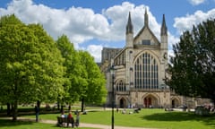 Winchester Cathedral, Hampshire, England, UK - with people relaxing in the park