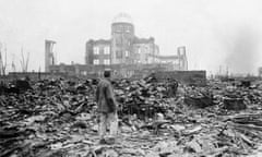 Man stands in front of the shell of building in Hiroshima, Japan, a month after the US dropped its atomic bomb in 1945