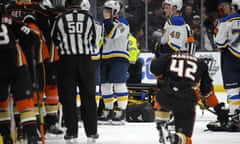 Players from both teams gather after Jay Bouwmeester’s collapse